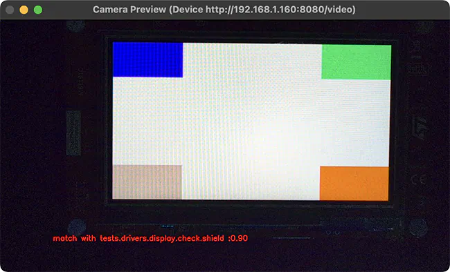A window showing a camera preview of a device display with colored blocks in the corners, with a text overlay indicating a successful test match.